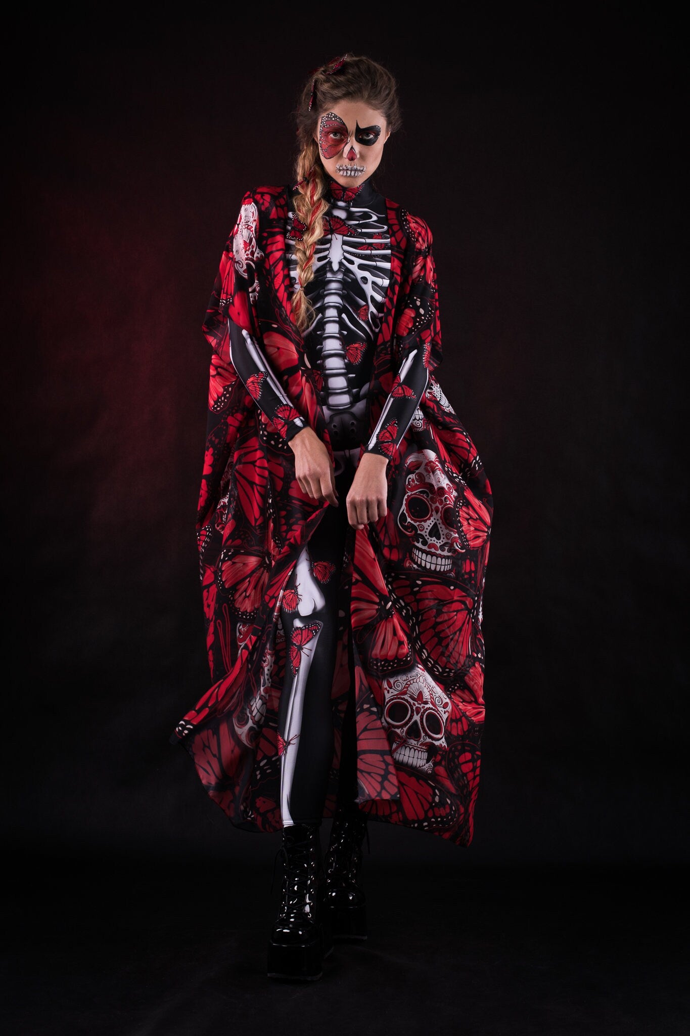 Woman wearing the Red Monarchy Butterflies kimono cape, featuring detailed butterfly accents and a flowing design, perfect for Day of the Dead or Halloween events.